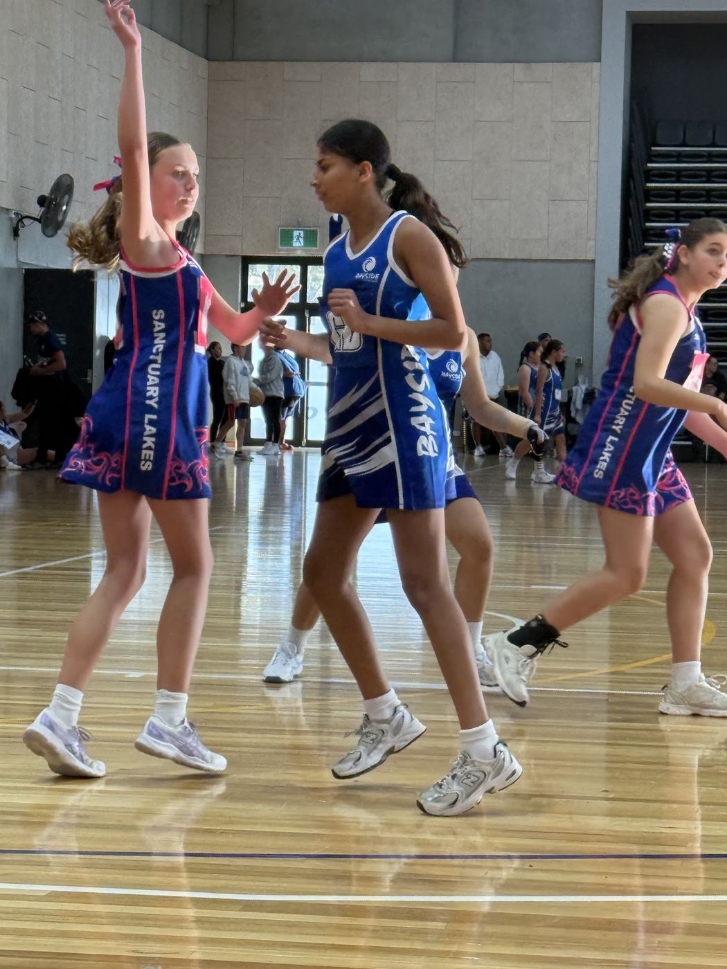 Bayside players on court in the indoor stadium