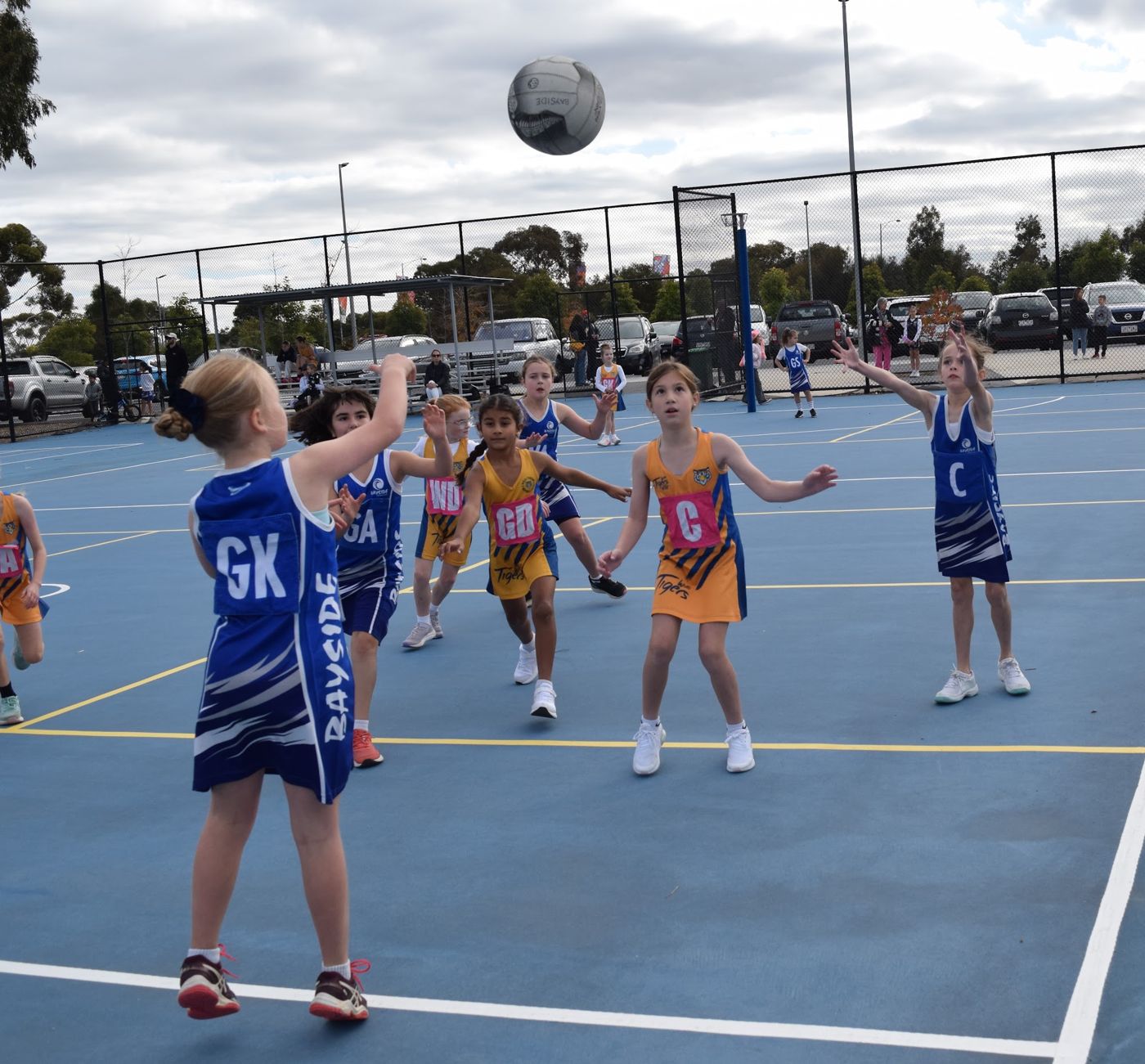 Bayside players watching the ball in the air on the outdoor courts