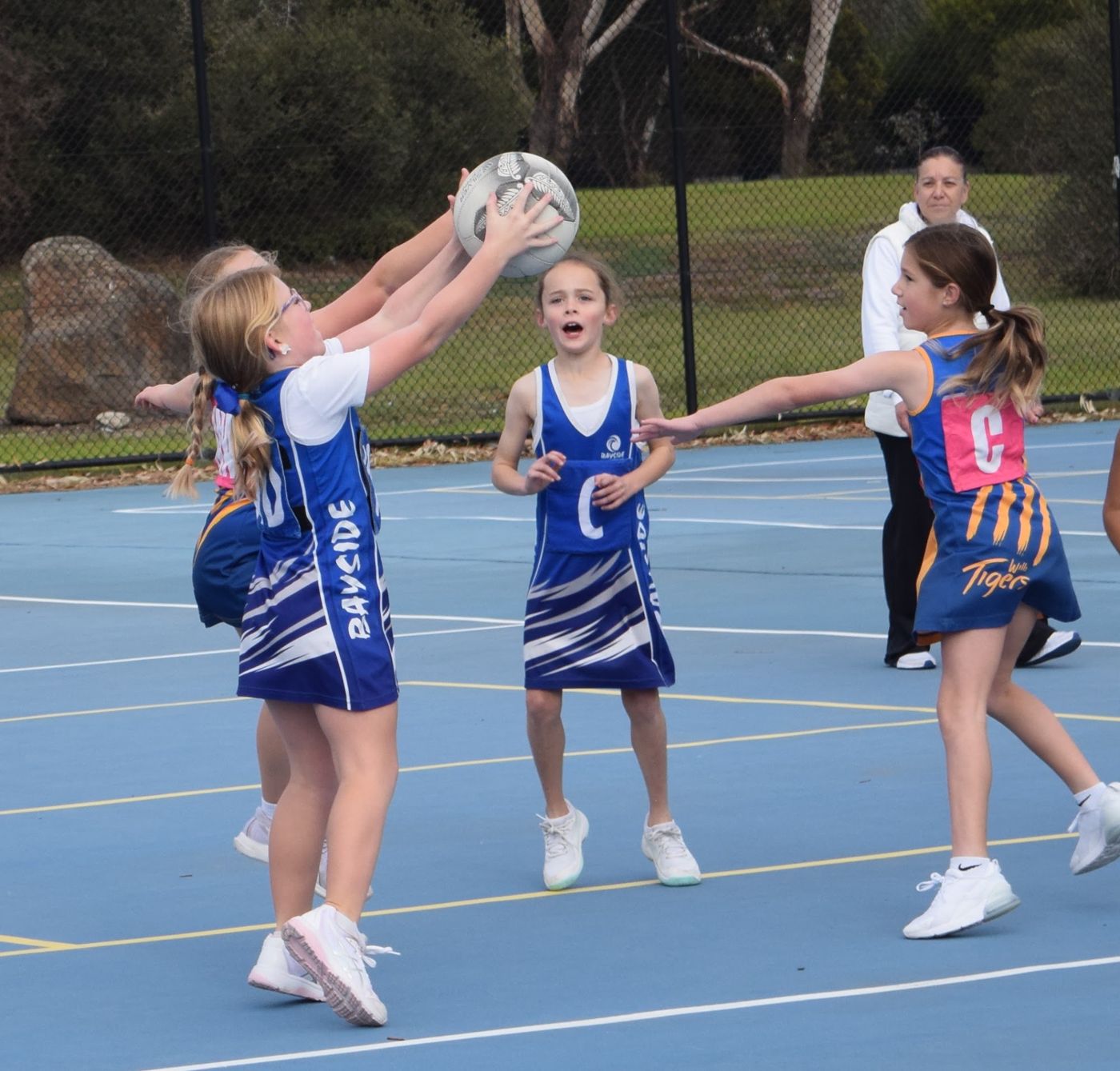A young Bayside player catching the ball under the post