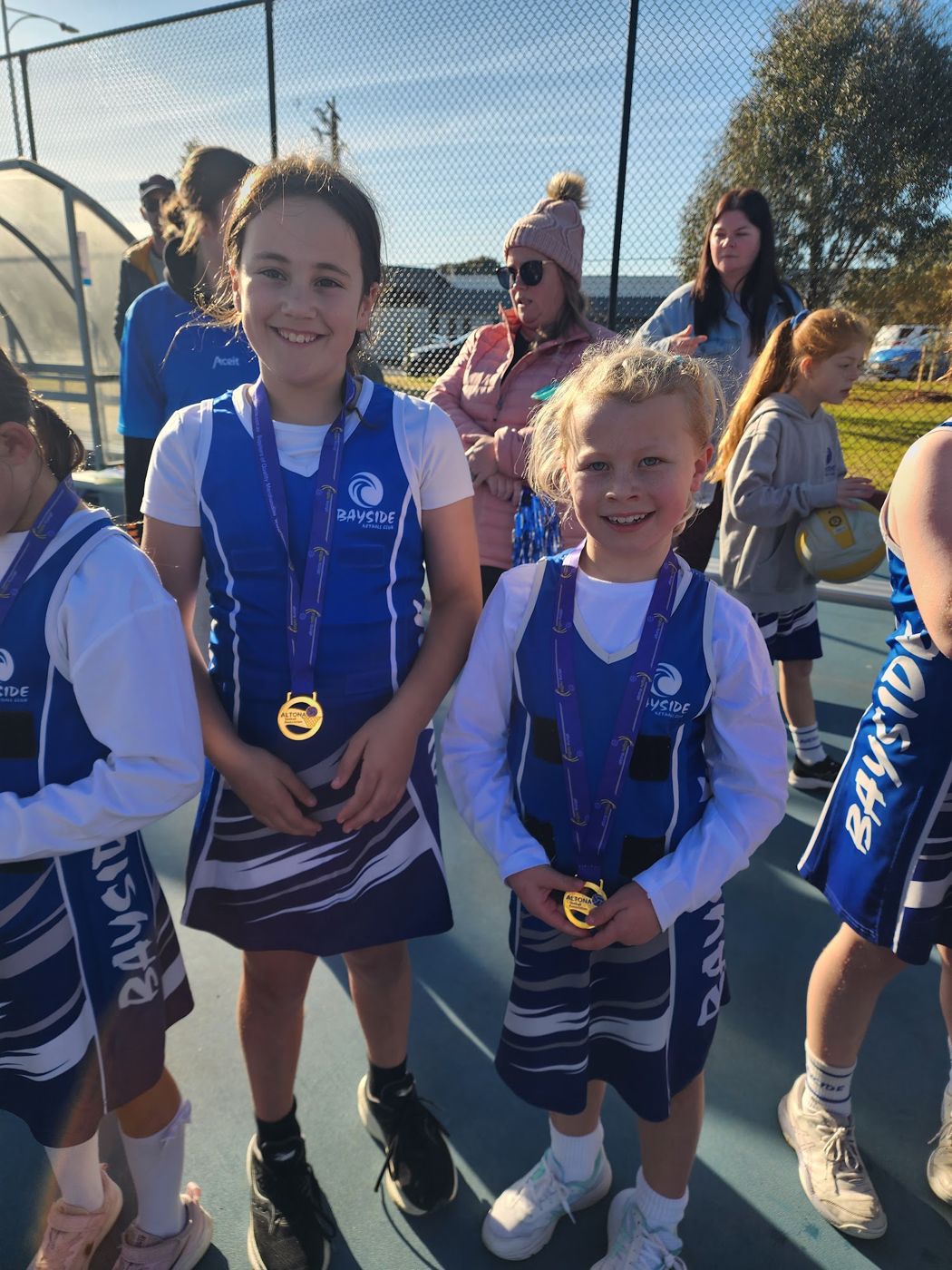 Two young Bayside players showing their medals